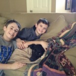 Alex and Michael relaxing with thier dog, Champ